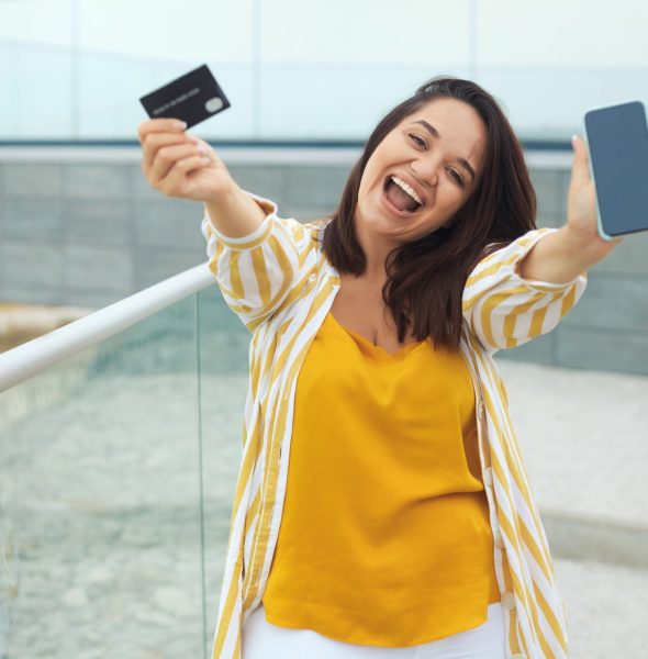 happy-woman-made-a-payment-with-a-bank-card-online-through-an-application-in-a-mobile-phone.jpg
